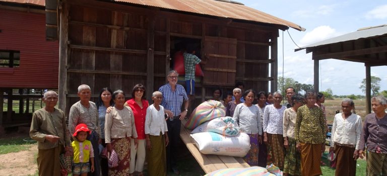 PHOTO 15 PARTNERS - TRUSTEES AND READA PROJECT MANAGER WITH COMMNITY REPAYING RICE RESIZED